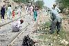Railway workers repair track after derail of  cargo-train in Dera Allahyar area in Jaffarabad